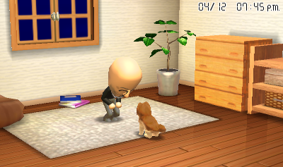 Mike in his apartment, bending down so he can see his dog.