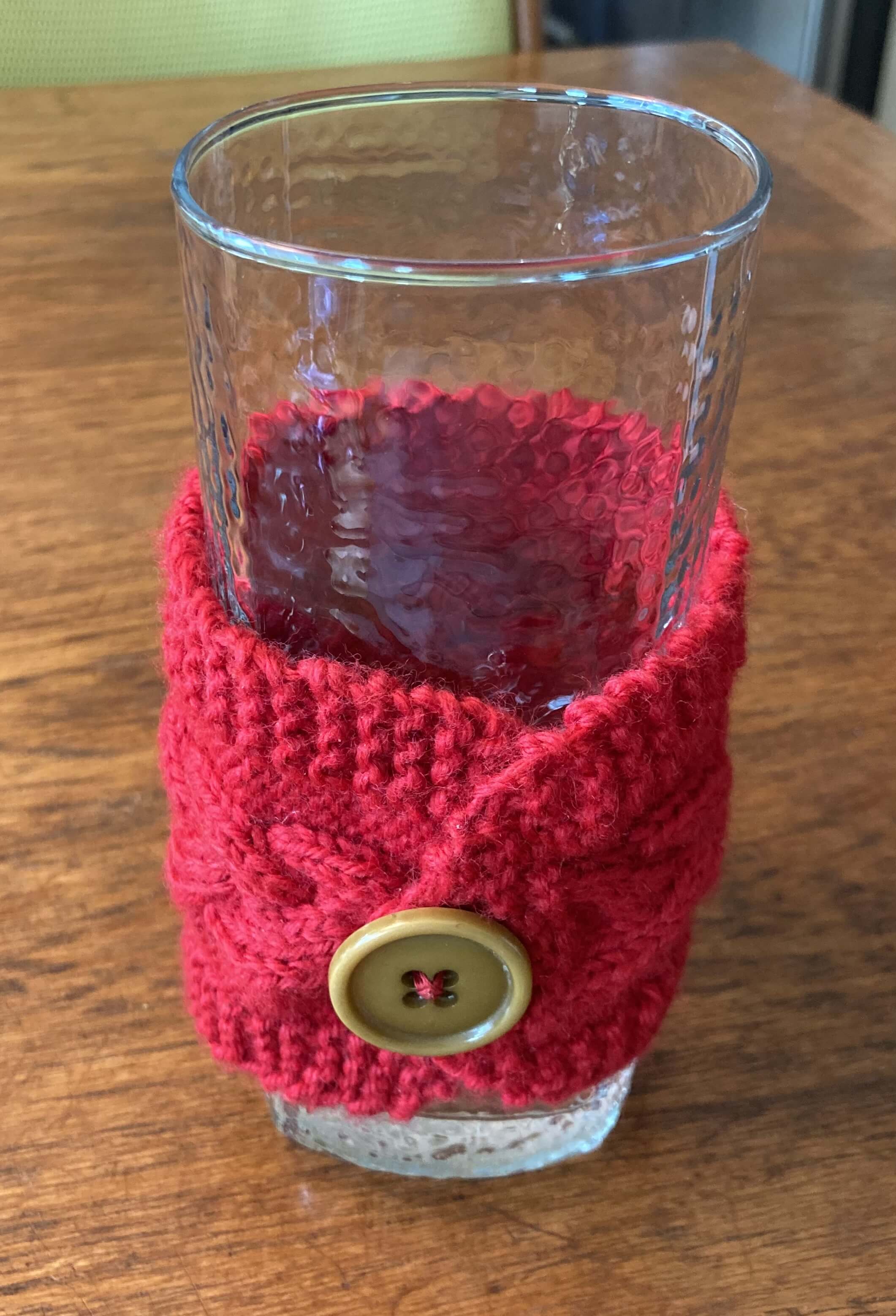 The mug cozy wrapped around a glass (front).