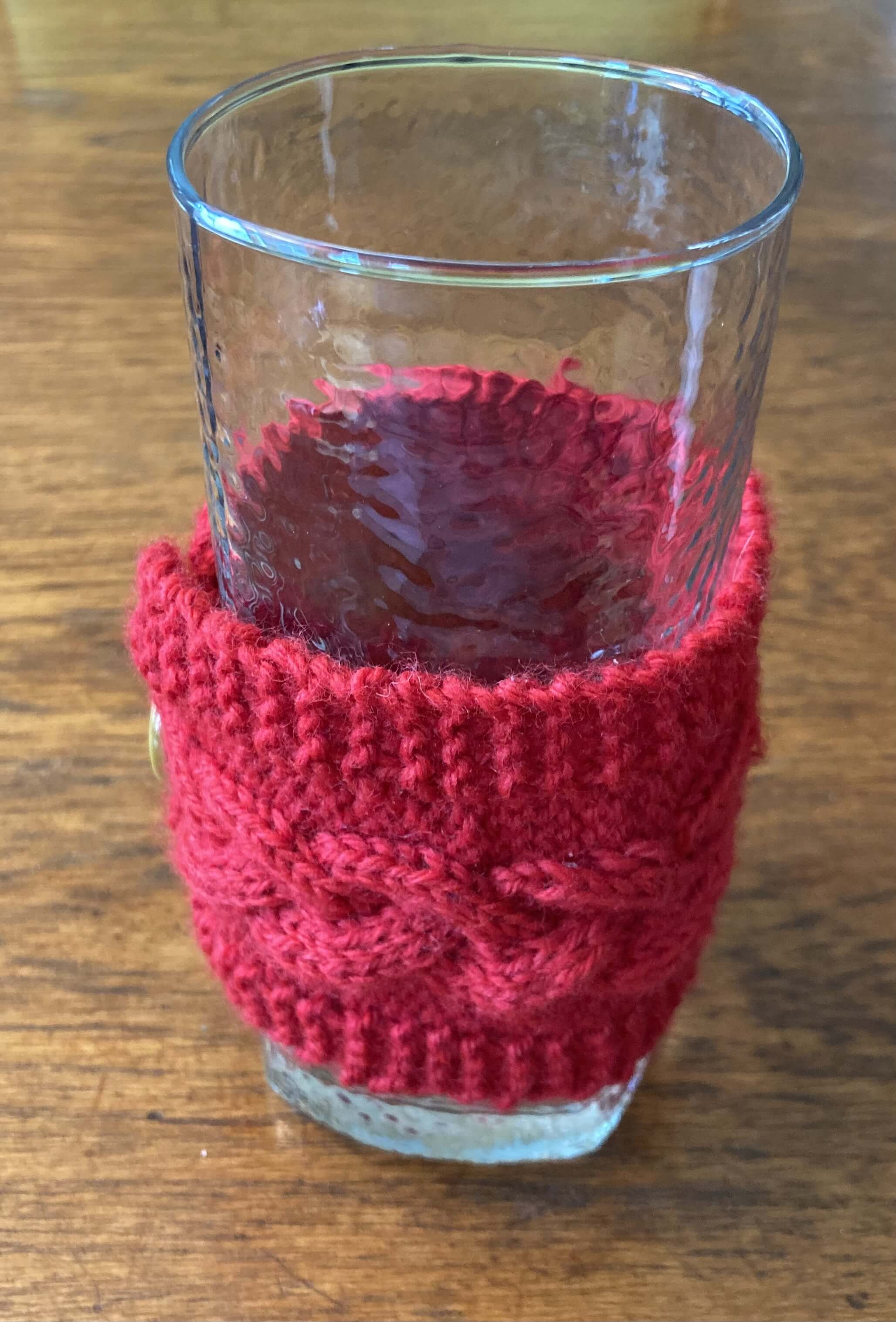 The mug cozy wrapped around a glass (side view).