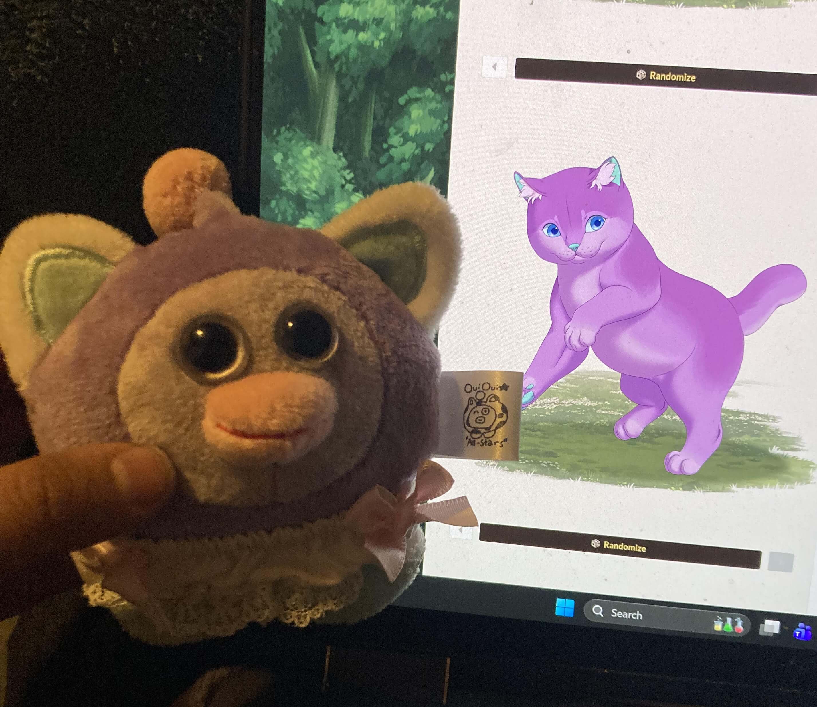 Stinker OuiOui being held up in front of my computer monitor, which shows a cartoon solid purple cat.